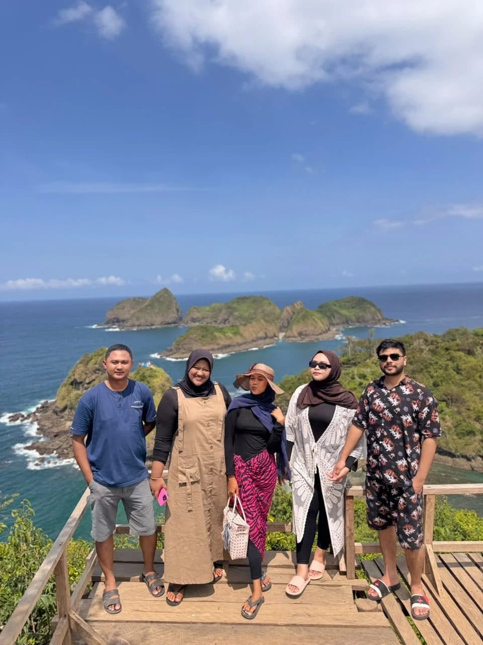 Guests on the Green Island lookout deck with the islands behind