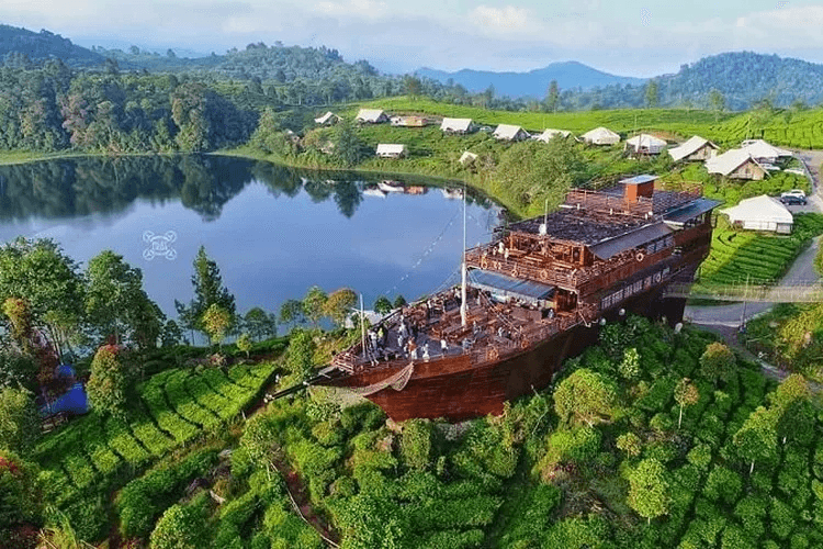 Glamping tents and a wooden boat café above Situ Patenggang