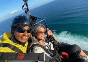 Guests and instructor flying over the ocean