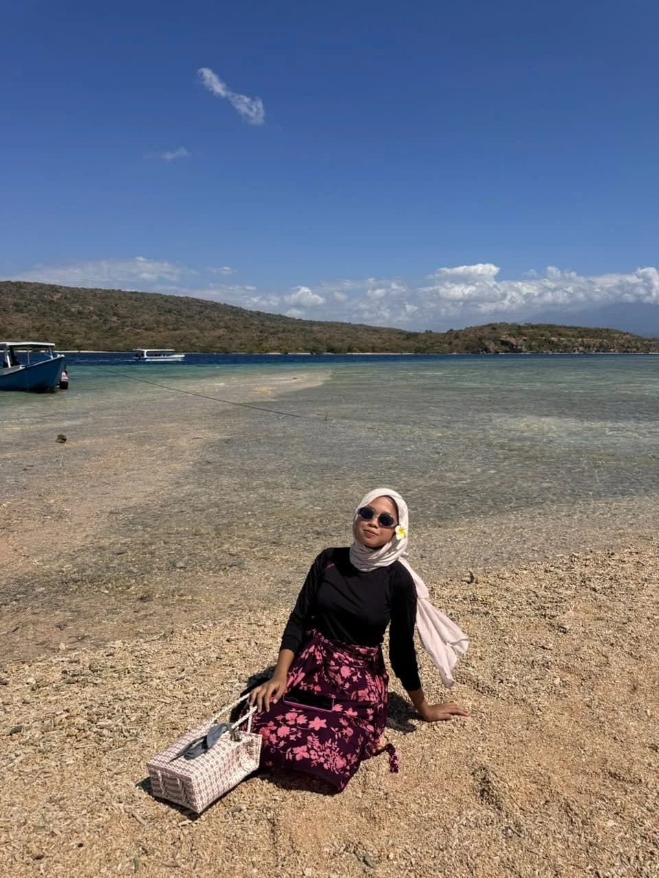 Coral beach and boats on Menjangan Island