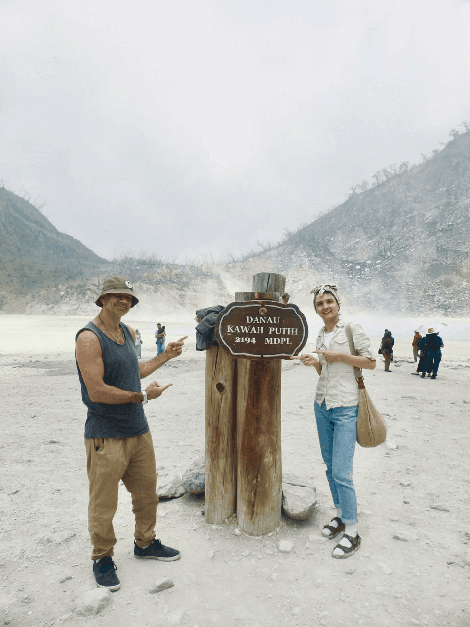 Guests at the Kawah Putih crater lake sign
